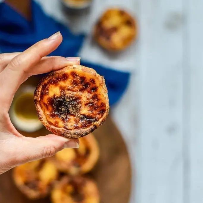 Pastel de nata close-up met krokante bladerdeegkorst en romige custardvulling